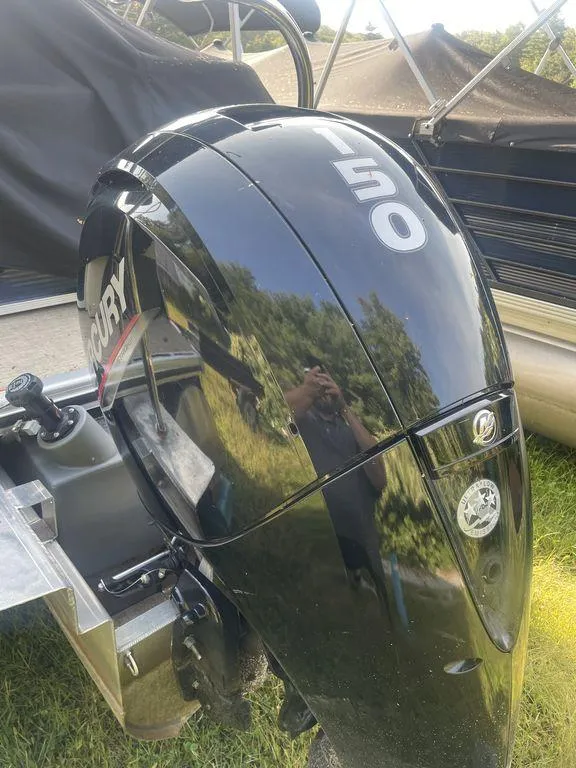 Slide: The Image of Close-up of a Mercury 150 outboard motor on a 2021 Harris CRUISER 250 CW P3 boat. - 6