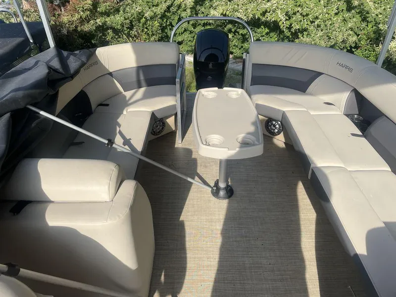 Slide: The Image of 2021 Harris CRUISER 250 CW P3 boat interior with beige seating and table. - 7