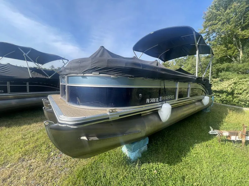 Slide: The Image of 2021 Harris CRUISER 250 CW P3 pontoon boat on grass with cover and canopy. - 8