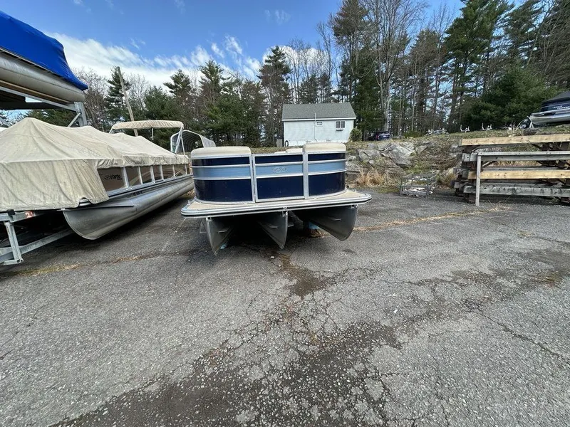 Slide: The Image of 2021 Harris CRUISER 250 CW P3 pontoon boat in outdoor storage area. - 9