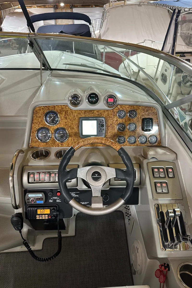 Slide: The Image of 2007 Formula 310 Sun Sport boat dashboard with steering wheel and control panel. - 10
