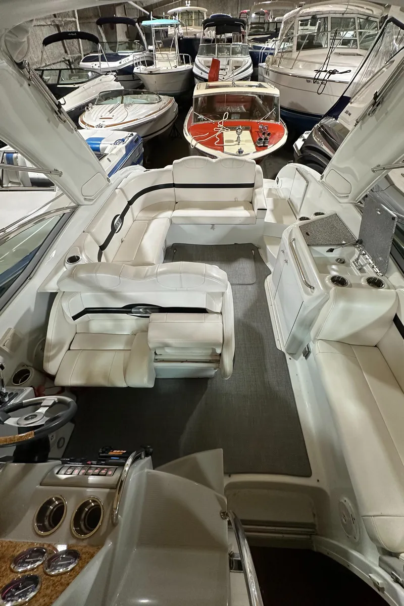 Slide: The Image of 2007 Formula 310 Sun Sport boat interior with white seating, docked among other boats. - 11