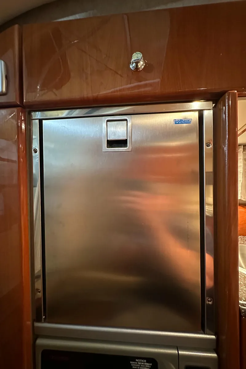 Slide: The Image of Stainless steel refrigerator in 2007 Formula 310 Sun Sport boat interior. - 16