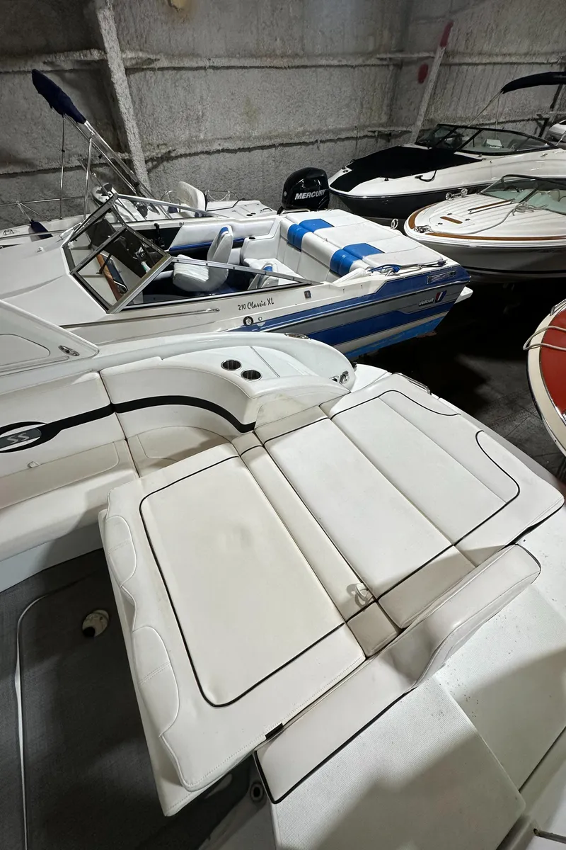 Slide: The Image of 2007 Formula 310 Sun Sport boat in storage, featuring sleek white seating and modern design. - 4