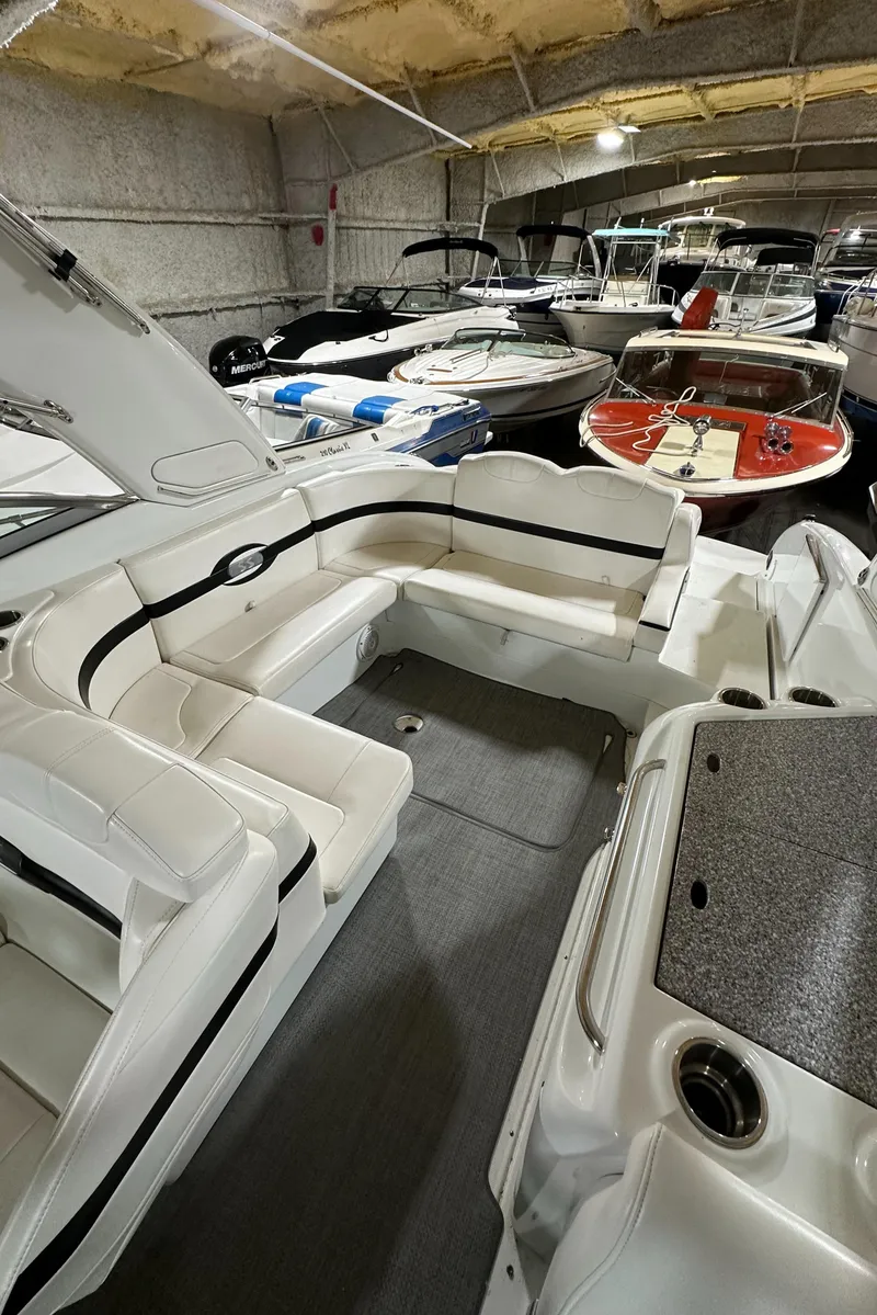 Slide: The Image of 2007 Formula 310 Sun Sport boat interior in storage, featuring white seating and modern design. - 5