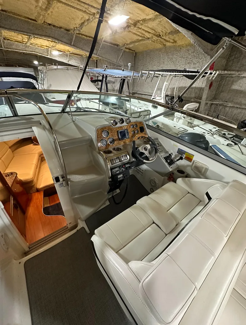 Slide: The Image of 2007 Formula 310 Sun Sport boat interior with white seating and wooden dashboard. - 8
