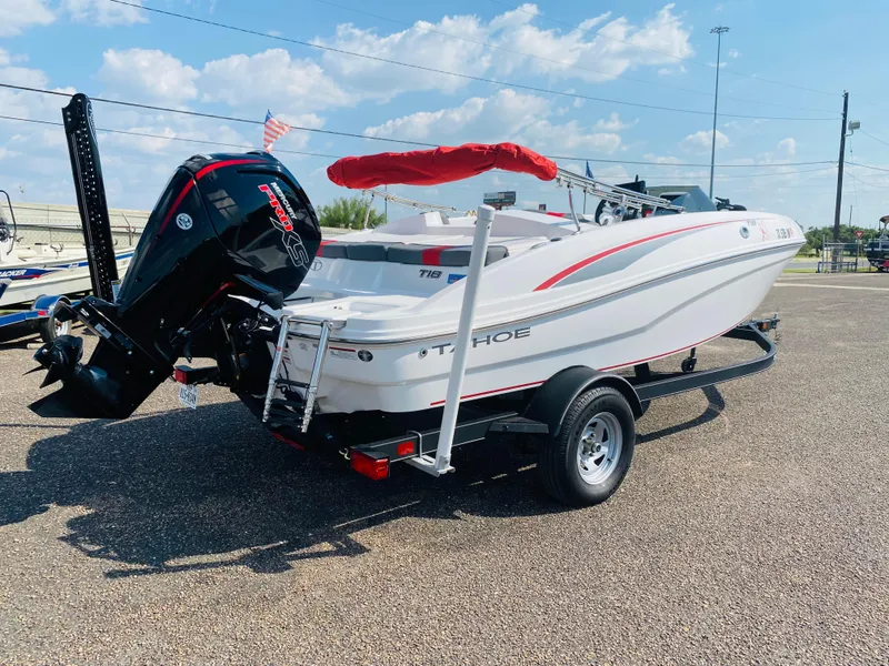 Slide: The Image of 2024 Tahoe T18 boat on trailer, featuring outboard motor and red canopy. - 6