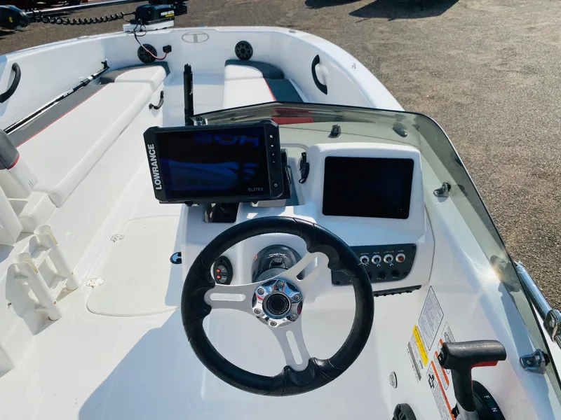 Slide: The Image of 2024 Tahoe T18 boat dashboard with steering wheel and navigation screens. - 7