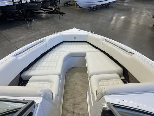 Slide: The Image of 2020 Cobalt R7 Surf boat with spacious white seating in showroom. - 14