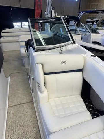 Slide: The Image of 2020 Cobalt R7 Surf boat with white leather seating in showroom. - 16