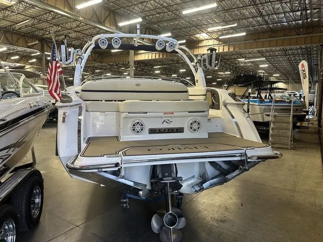 Slide: The Image of 2020 Cobalt R7 Surf boat in showroom, rear view with American flag. - 5