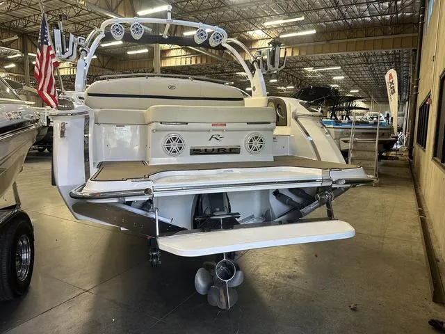 Slide: The Image of 2020 Cobalt R7 Surf boat in a warehouse, rear view with American flag. - 6