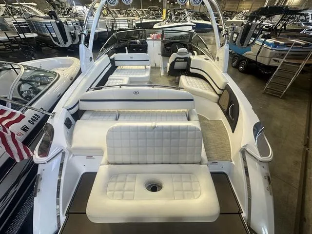 Slide: The Image of 2020 Cobalt R7 Surf boat with spacious white seating in a showroom. - 8