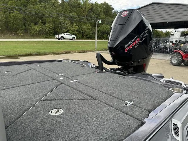 Slide: The Image of 2025 Bass Cat Puma STS boat with Mercury engine, parked outdoors. - 11