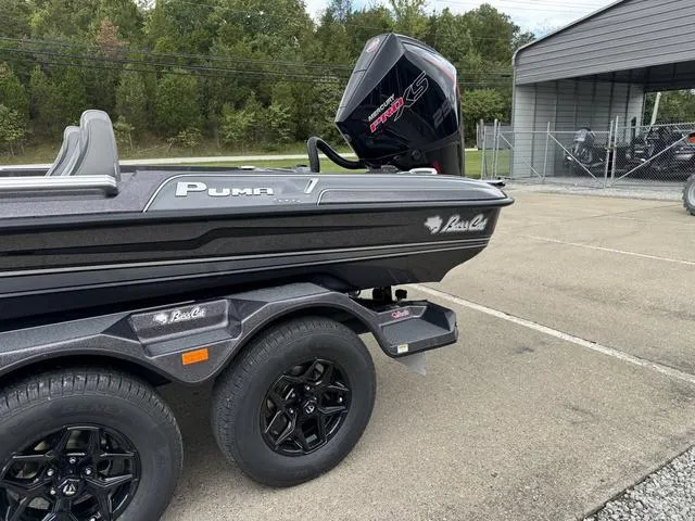 Slide: The Image of 2025 Bass Cat Puma STS boat on trailer, parked outdoors. - 14