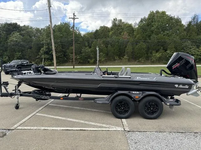 Slide: The Image of 2025 Bass Cat Puma STS boat on trailer, parked outdoors. - 15
