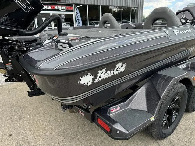 Slide: The Image of 2025 Bass Cat Puma STS boat, sleek design, parked on trailer. - 4
