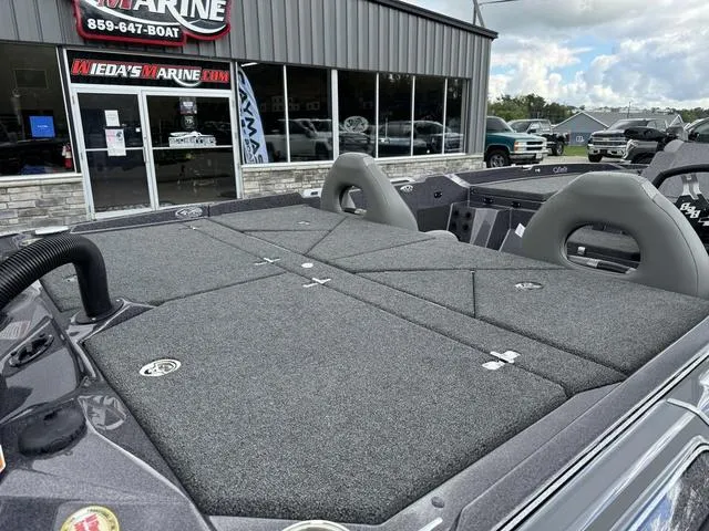 Slide: The Image of 2025 Bass Cat Puma STS boat at dealership, showcasing spacious deck and seating. - 5