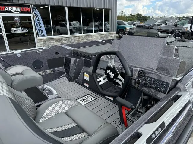 Slide: The Image of 2025 Bass Cat Puma STS boat interior with modern dashboard and seating. - 6