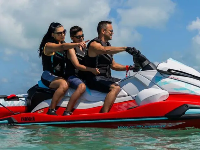 Slide: The Image of 2025 Yamaha Waverunner VX Limited with three riders enjoying a sunny day on the water. - 5