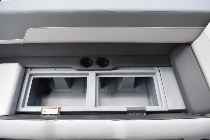 Slide: The Image of 2025 Lowe LS210WT TL boat storage compartments with cup holders, featuring sleek gray interior design. - 15