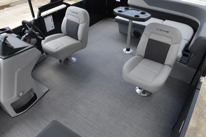 Slide: The Image of 2025 Lowe LS210WT TL boat interior with gray seating and modern helm. - 23