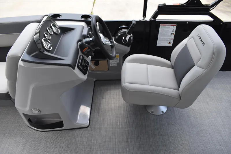 Slide: The Image of Captain's seat and helm of 2025 Lowe LS210WT TL boat, featuring modern controls and gauges. - 24