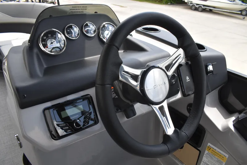 Slide: The Image of Steering console of 2025 Lowe LS210WT TL boat with gauges and controls. - 26