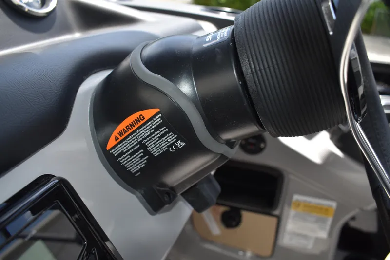 Slide: The Image of Close-up of a 2025 Lowe LS210WT TL boat steering mechanism with warning label. - 28