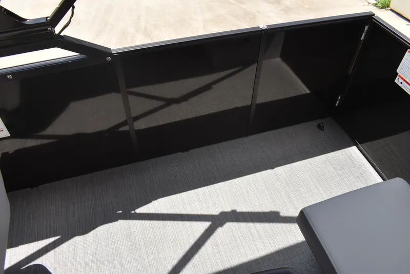 Slide: The Image of Interior view of 2025 Lowe LS210WT TL boat with sleek black panels and gray flooring. - 34