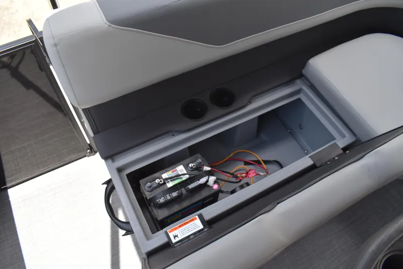 Slide: The Image of Open storage compartment in a 2025 Lowe LS210WT TL boat, revealing battery and wiring. - 36