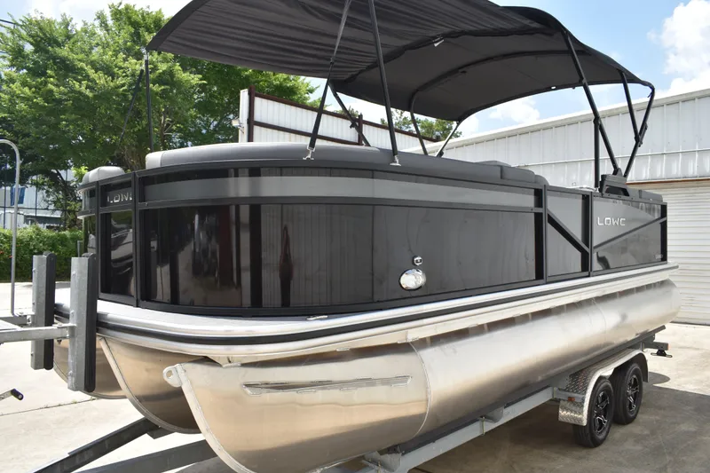 Slide: The Image of 2025 Lowe LS210WT TL pontoon boat with black canopy on trailer. - 6