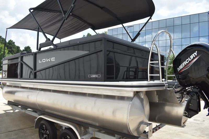 Slide: The Image of 2025 Lowe LS210WT TL pontoon boat with Mercury engine, parked on trailer. - 7