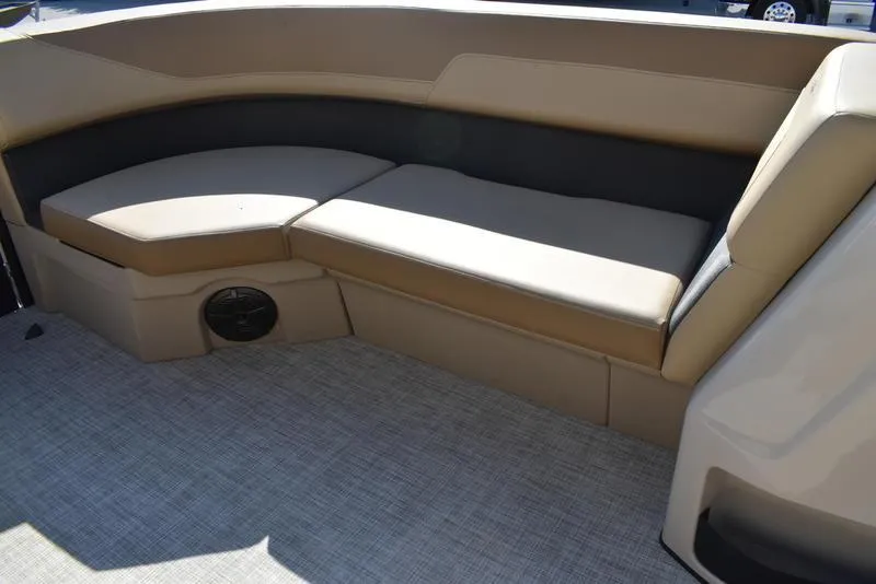 Slide: The Image of 2025 Lowe LS190 boat interior with beige seating and carpeted flooring. - 10