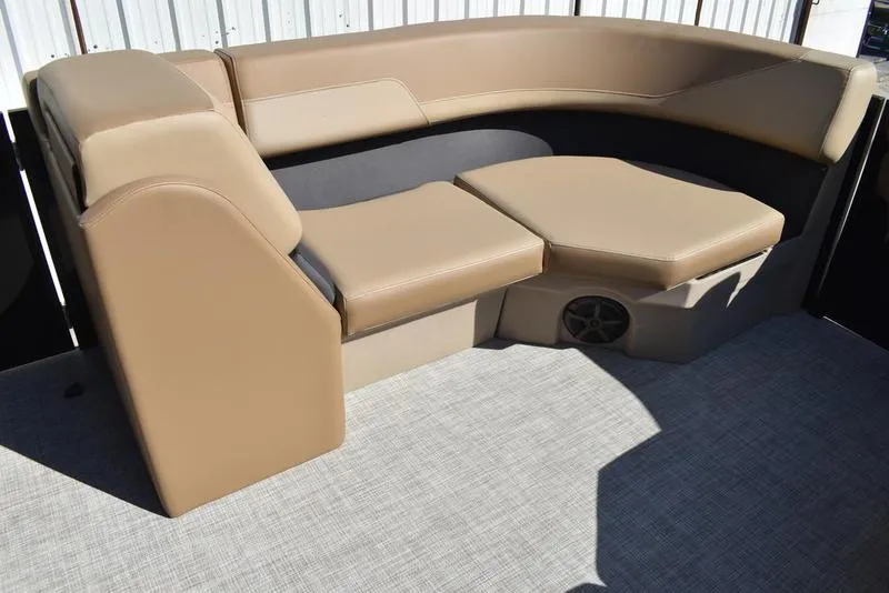 Slide: The Image of 2025 Lowe LS190 boat interior with tan seating and speaker. - 11
