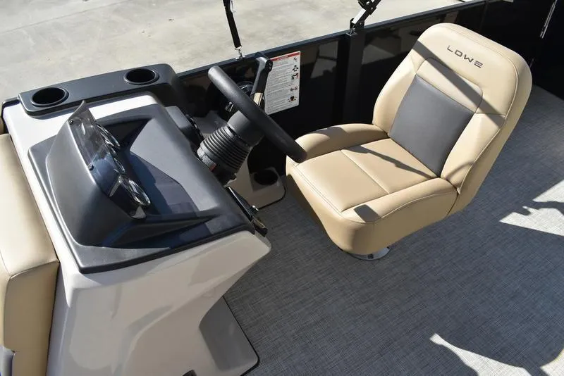 Slide: The Image of 2025 Lowe LS190 boat interior with steering console and beige captain's chair. - 14