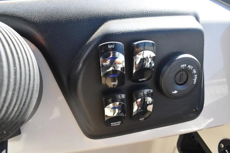 Slide: The Image of Control panel of 2025 Lowe LS190 boat with switches and ignition. - 17