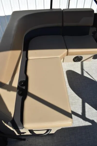 Slide: The Image of 2025 Lowe LS190 boat interior with beige seating and speaker. - 25
