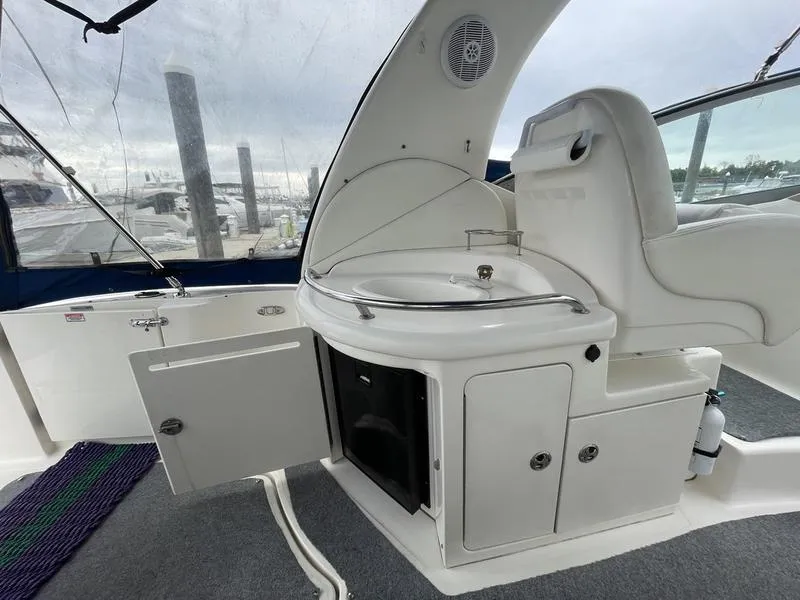 Slide: The Image of 2003 Sea Ray 340 Sundancer cockpit with sink and storage cabinets. - 15