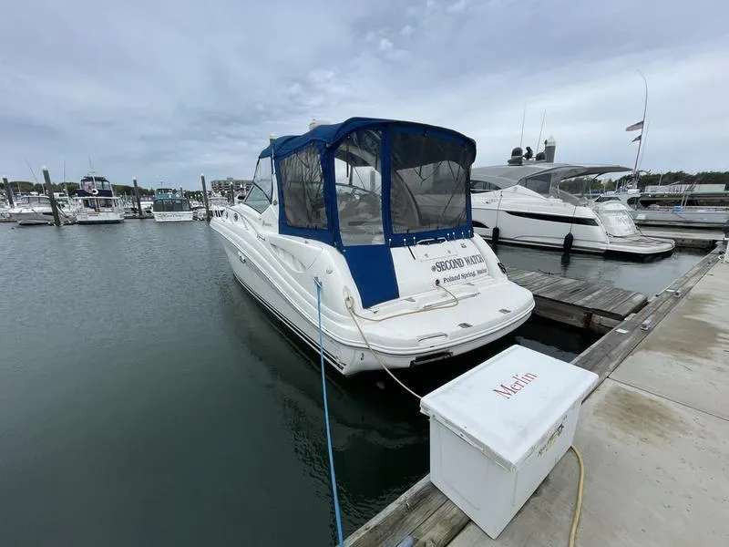 Slide: The Image of 2003 Sea Ray 340 Sundancer docked at marina with blue canopy. - 2