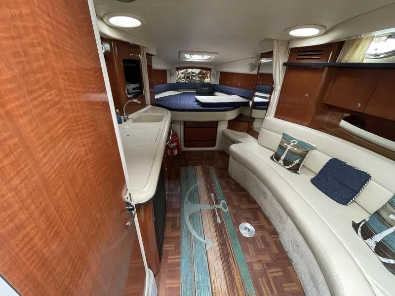 Slide: The Image of Interior of 2003 Sea Ray 340 Sundancer yacht with cozy seating and wood accents. - 5