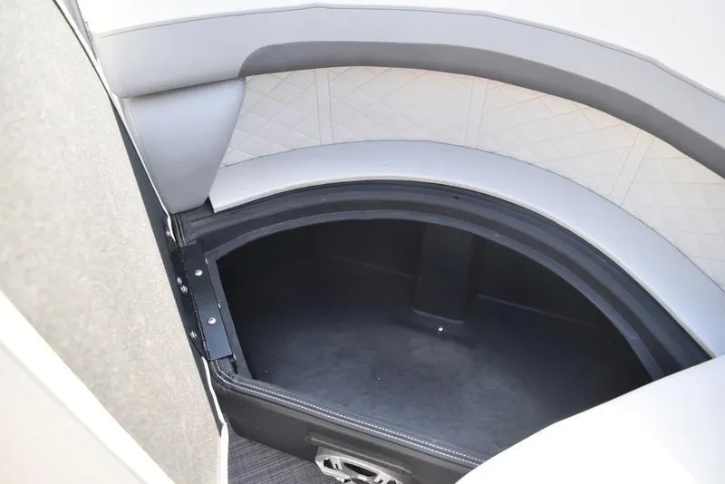 Slide: The Image of 2023 Lowe SS 210 DL boat interior storage compartment with cup holder. - 14
