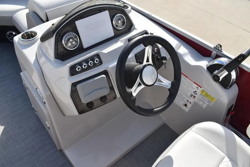 Slide: The Image of 2023 Lowe SS 210 DL boat dashboard with steering wheel and controls. - 18