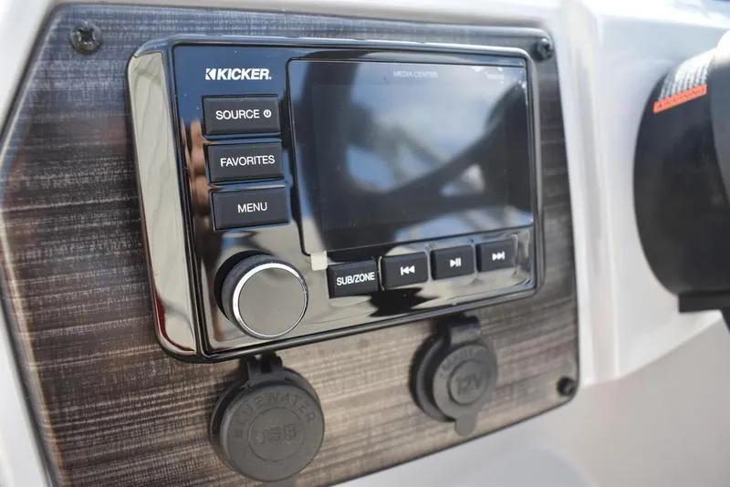 Slide: The Image of Control panel of 2023 Lowe SS 210 DL boat with switches and Kicker audio system. - 20