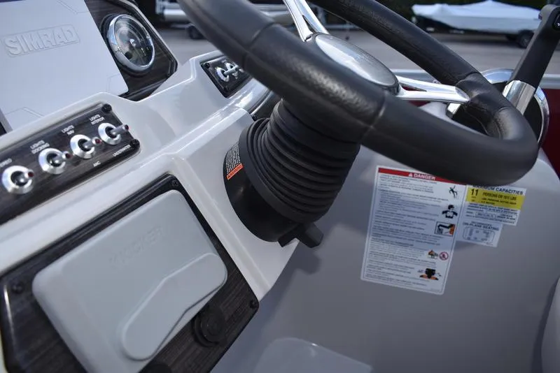 Slide: The Image of Control panel of 2023 Lowe SS 210 DL boat with switches and ignition key. - 27