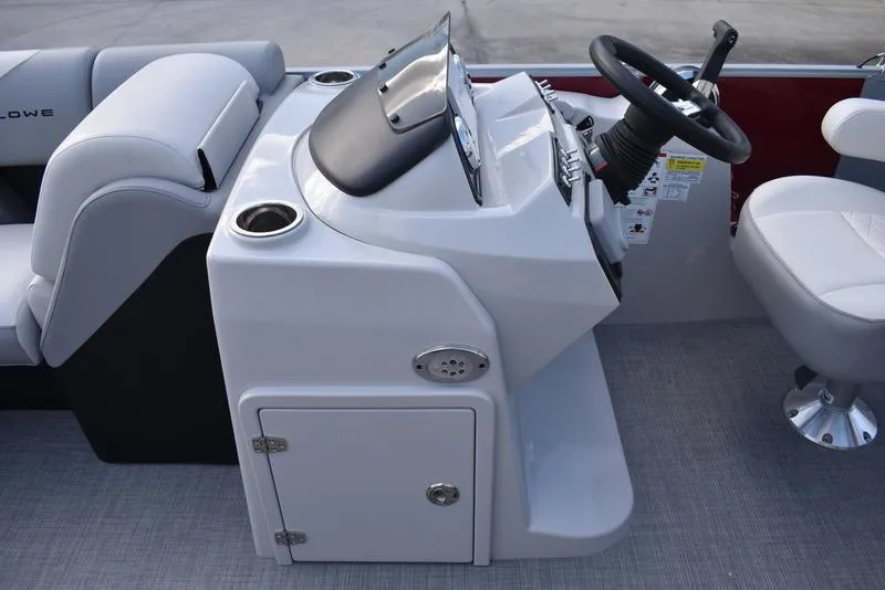 Slide: The Image of 2023 Lowe SS 210 DL boat console with steering wheel and seating. - 28