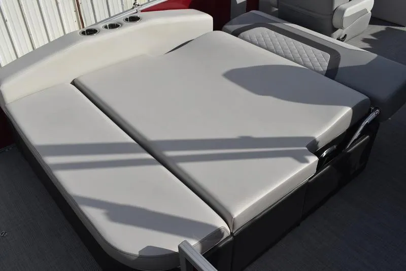 Slide: The Image of 2023 Lowe SS 210 DL boat interior with cushioned seating and cup holders. - 37