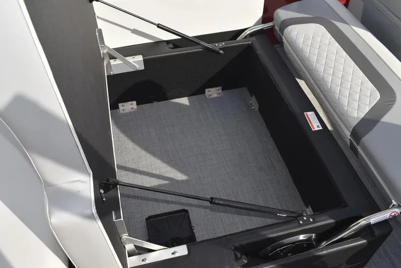 Slide: The Image of Open storage compartment in 2023 Lowe SS 210 DL boat with cushioned seating. - 39