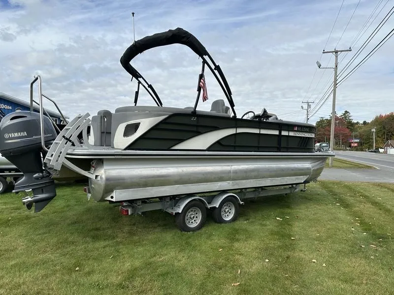 Slide: The Image of 2021 Bennington 22 LFB pontoon boat on trailer, parked on grass. - 14