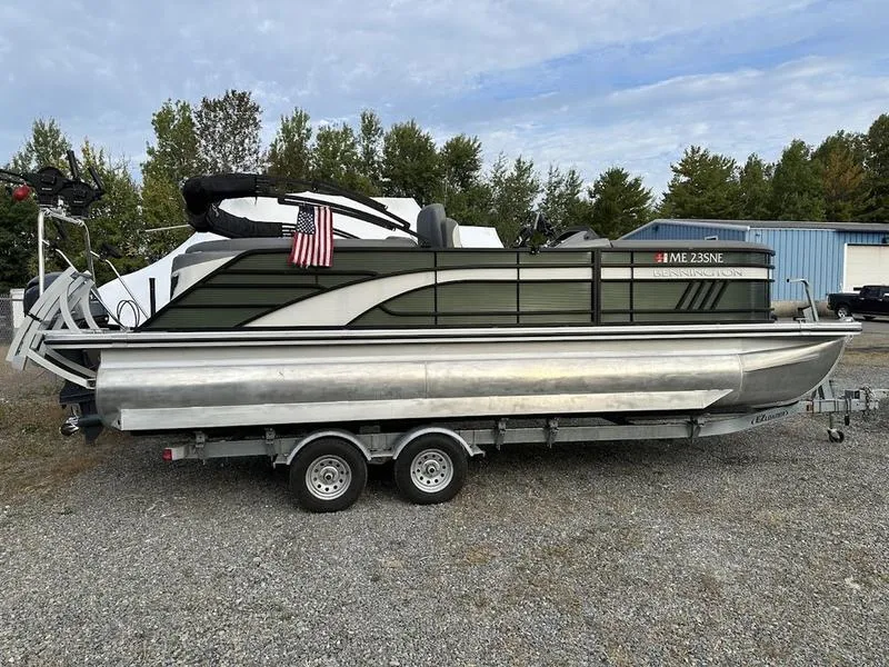 Slide: The Image of 2021 Bennington 22 LFB pontoon boat on trailer, parked outdoors. - 3